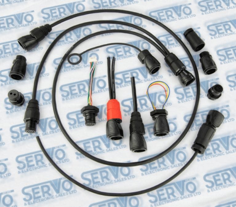 A collection of Click Connect series connectors laid out on Servo Electronics Branded tissue paper